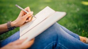 Women outside using ai journaling prompts to reflect on a beautiful day