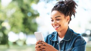 Women happily ai journaling on her iphone to reduce stress and anxiety